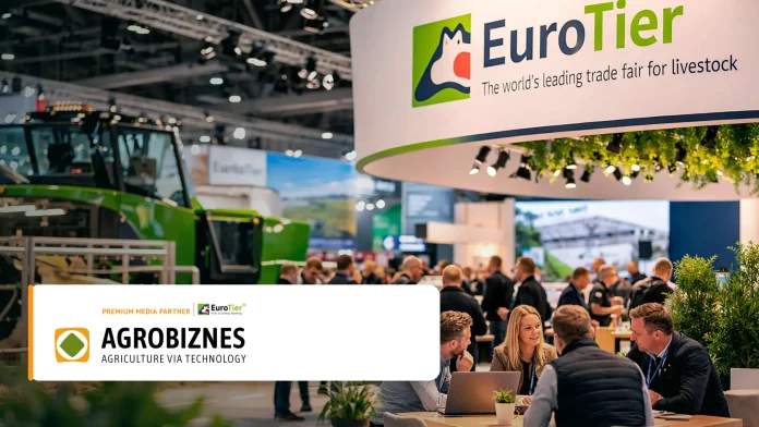 Busy agricultural trade show booth with EuroTier branding and crowd of attendees exploring exhibits.